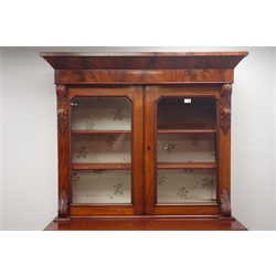  Victorian mahogany bookcase on cupboard, projecting cornice, two glazed doors enclosing shelves above single drawers and two cupboards on turned feet, W120cm, H200cm, D54cm  