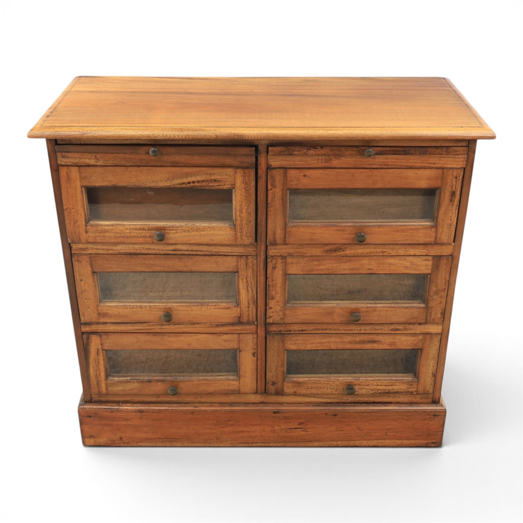 20th century Haberdashery style hardwood chest, two brushing slides, with six glass fronted drawers, blackened metal pulls, plinth base 