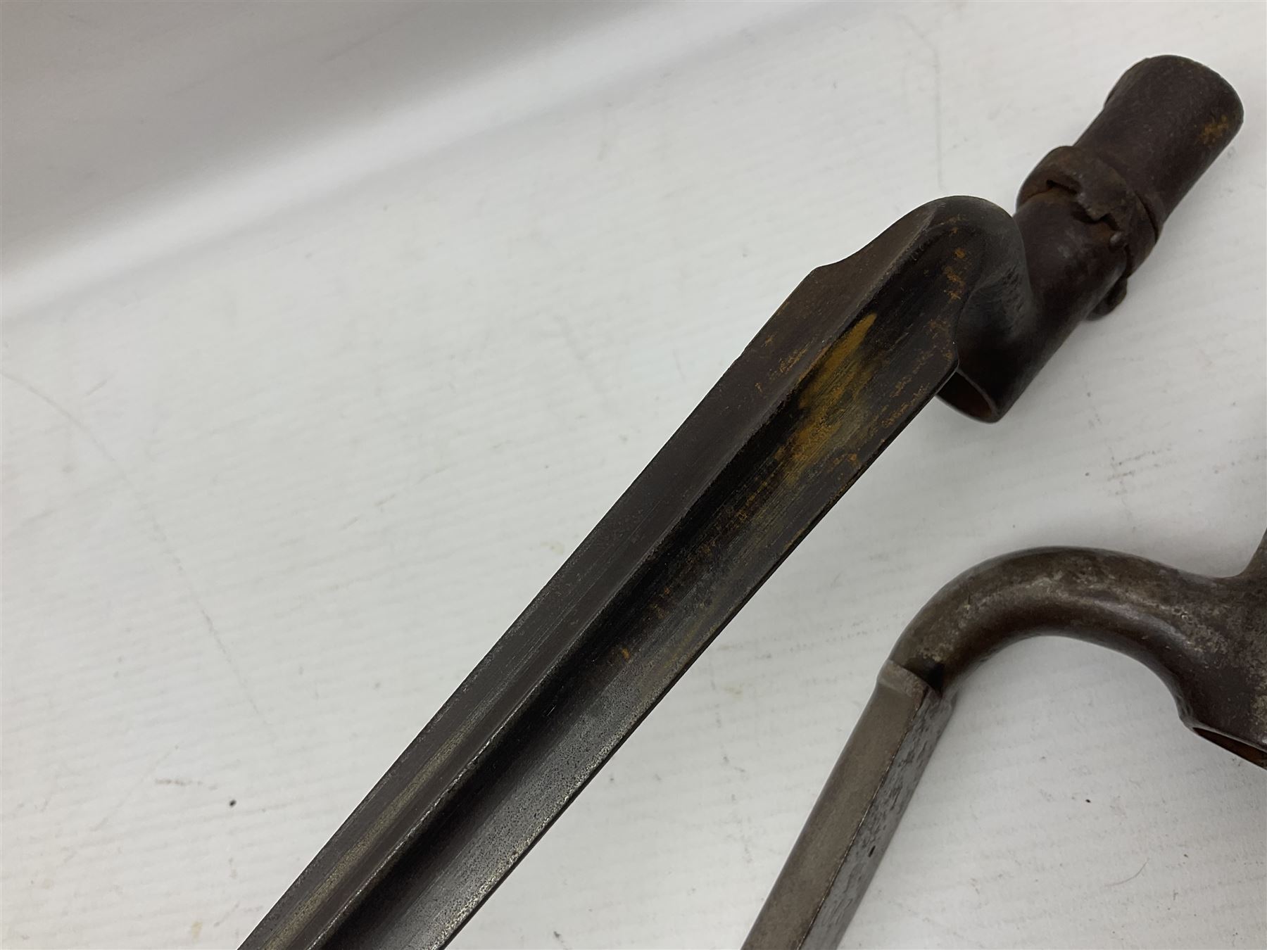 Early 19th century British Brown Bess musket rifle socket bayonet with zigzag fitting stamped D71 and triangular blade stamped 270 L55cm overall; and two other 19th century socket bayonets; no scabbards (3)