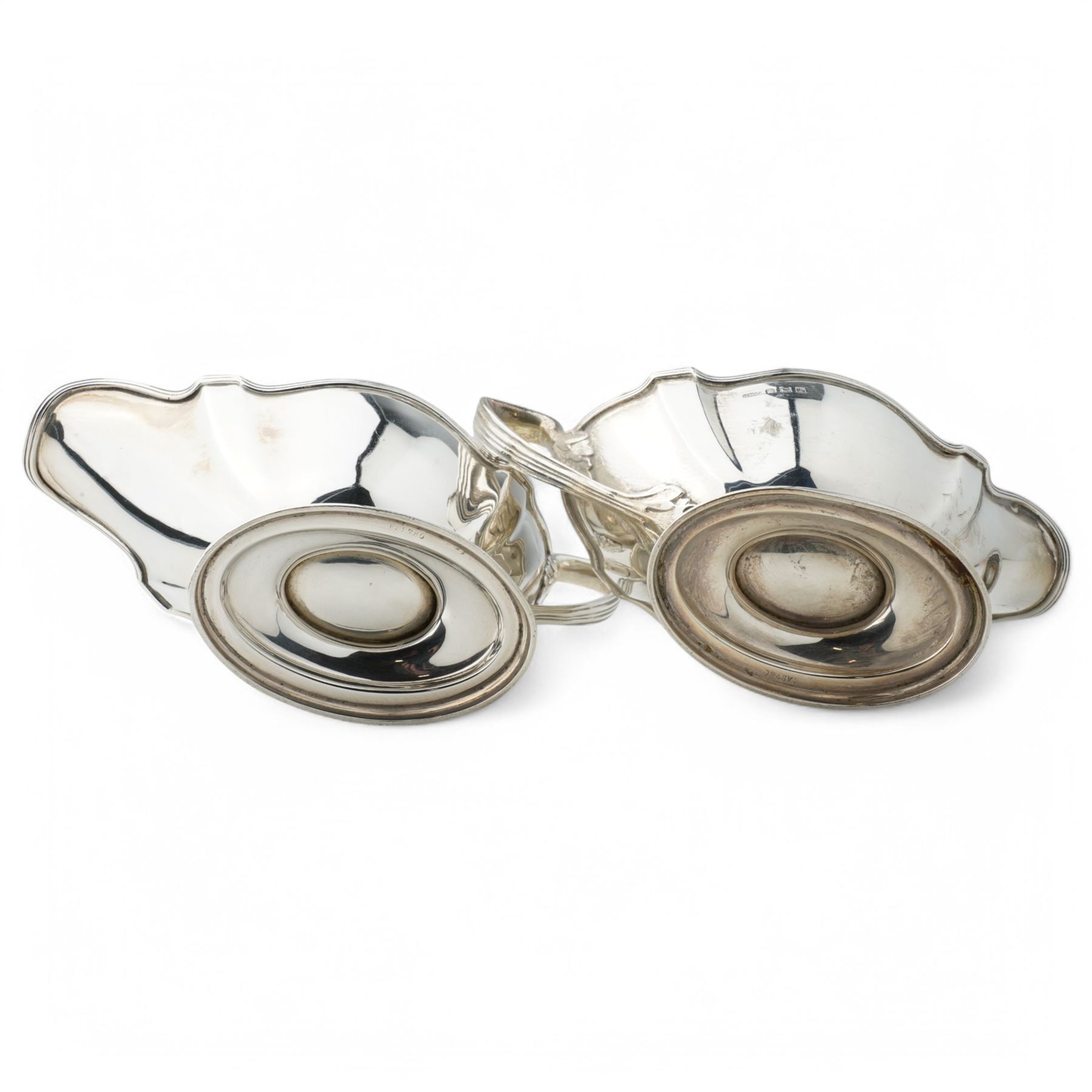 Pair of silver sauce boats with crimped reeded rims, angular handle and on pedestal foot Birmingham 1916 Maker Gorham Manufacturing Co.