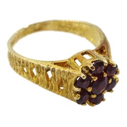 9ct gold garnet flower head cluster ring, with textured and pierced shoulders by Slade & Kempton, London 1978
