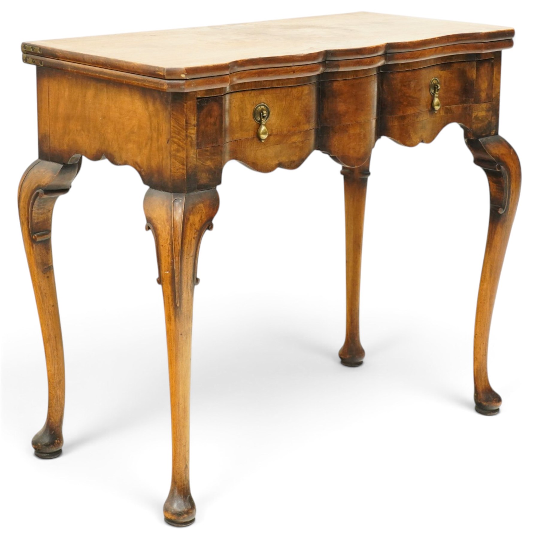 Quality early 20th century Queen Anne design walnut card table, rectangular book-matched veneer fold-over and swivel top with scalloped edge enclosing baize-lined interior, fitted with shaped frieze drawer with brass pear-drop handles over shaped apron, raised on C-scroll carved cabriole supports with pad feet