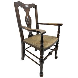 Georgian design oak country armchair, pieced shaped back splat over rush seat, raised on turned cabriole supports united by swell-turned front stretcher, on ball feet