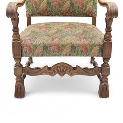 Early 20th-century Jacobean revival open oak armchair, arched padded back, and seat button upholstered  in foliate tapestry style fabric, with scroll carved arms on turned supports, raised on block supports united by turned shaped stretchers 