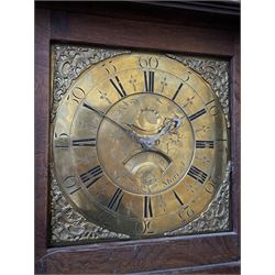 18th century c1760 oak cased George III longcase clock by William Eastwood of Burnley, with a stepped caddy top on a projecting cornice and blind frieze, square glazed door flanked by two turned pillars with gesso capitals, trunk with conforming recessed pillars and a full length wavy topped door, on a square plinth with a raised panel and shaped skirting, 12” square brass dial, 11” chapter ring with Roman numerals and five-minute Arabic's,  