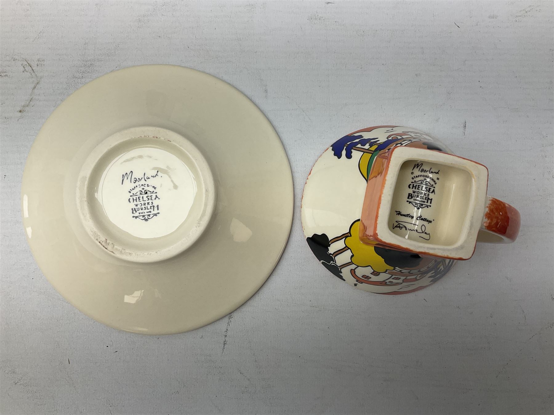 Two limited edition Bradford Exhange Clarice Cliff Age of Jazz beakers, no 289/4,999, with certificate, in box, together with a Moorland Art Deco Clarice Cliff style Huntley Cottage pattern teacup and saucer 