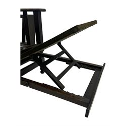 Late Victorian oak steamer chair, adjustable slatted backrest with grooved crest rail, wide armrests extending to a sliding adjustable footrest, open frame sides with vertical slats, side magazine rack and collapsible table, raised on turned front supports