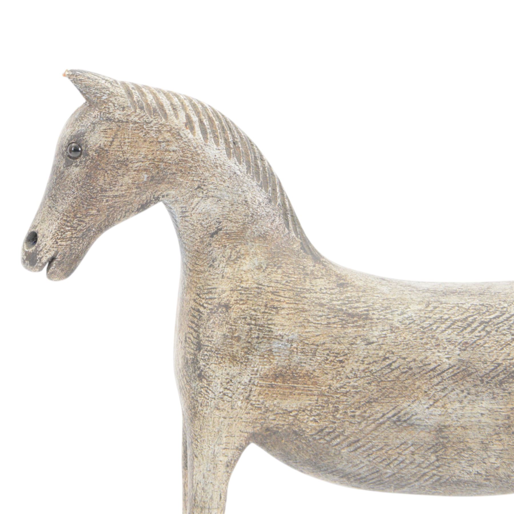 Carved Folk Art wooden horse, with glass eyes, H33cm