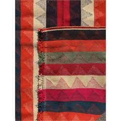 Southwest Persian Jajim Kilim ground rug, decorated with alternating vertical stripes in shades of crimson, orange, green, and black, with subtle triangular motifs woven into each stripe, bordered by narrow bands
