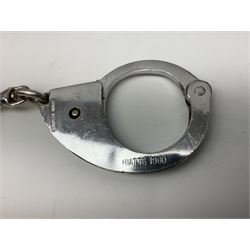 British Transport Police Custodian helmet with Queen's Crown plate; Hiatt & Co ebonised hardwood patrol truncheon; and pair of Hiatts 1960 hand-cuffs (3)