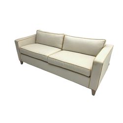 Neptune - pair three seat 'Shoreditch' sofas,  upholstered in cream fabric with yellow stringing