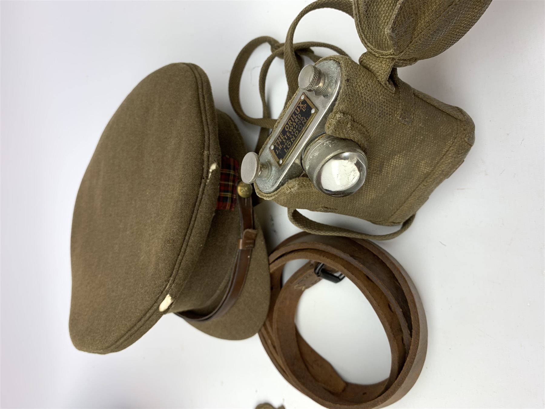 Scots Guards - two officer's peaked caps with chin strap and side buttons, one with badge, and blue dress peaked cap marked HEB for Harold Ellett-Brown; two Artist Rifles and one West Yorkshire cap badges and two Scots Guards shoulder flashes; officer's brown leather Sam Brown belt with shoulder brace strap and revolver holster; officer's Orilux trench torch etc