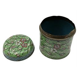 Late 19th century Chinese cloisonné box and cover, of cylindrical form decorated with prunus blossom, H8cm, together with an early 20th century Japanese cloisonné box and cover, of oval form upon four lobed feet, decorated with stylised flowers and motifs against a copper foil type ground, H7cm L12.5cm