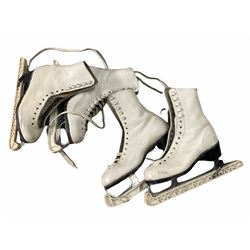 Two pair of leather ice skates, with steel blades and blade covers, sizes 3 and 3&1/2. 
