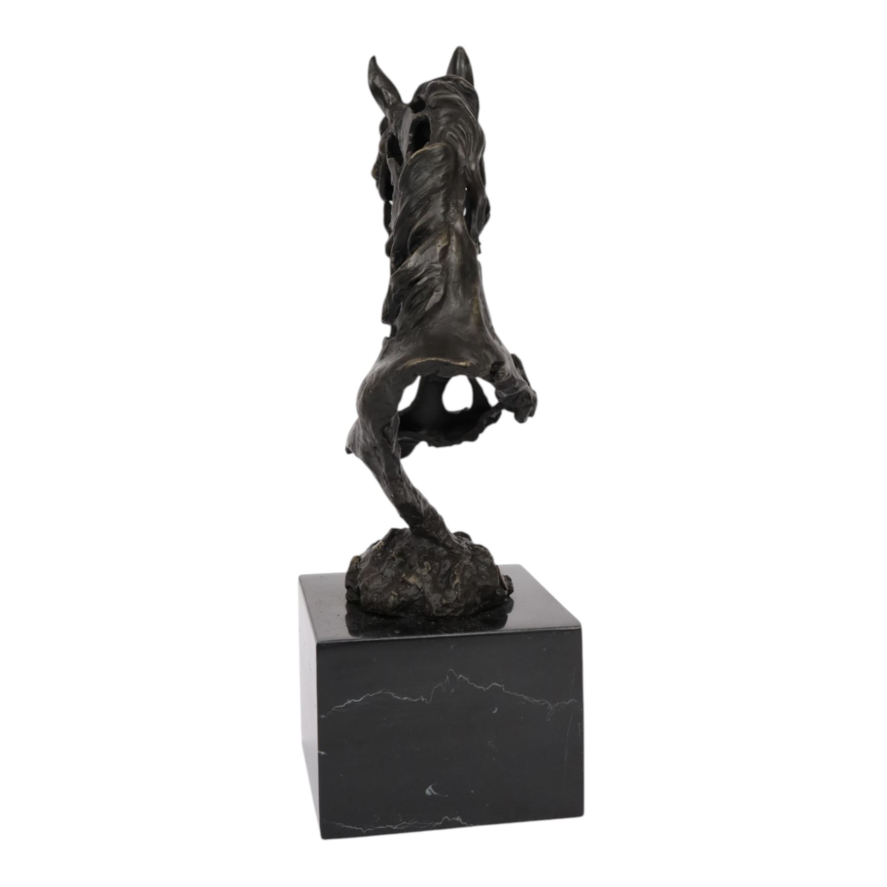 Stylised bronze model of an openwork horses head, signed Gadi and with foundry mark, raised upon black marble plinth, H41cm