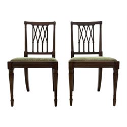 Pair late 19th century mahogany side chairs, the inlaid and reed carved cresting rail over lattice back, the turned uprights with carved foliage capitals, upholstered drop in seat, lobe carved and turned supports