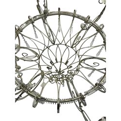 India Jane Interiors - six branch metal chandelier, the scrolled crown over circular bulbous body with six projecting branches, decorated with scroll work and glass pendants, in distressed white paint finish - ex-display/bankruptcy stock 