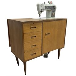 Mid-20th century teak sewing machine workstation, with Singer 611G sewing machine, fitted with four drawers and cupboard 