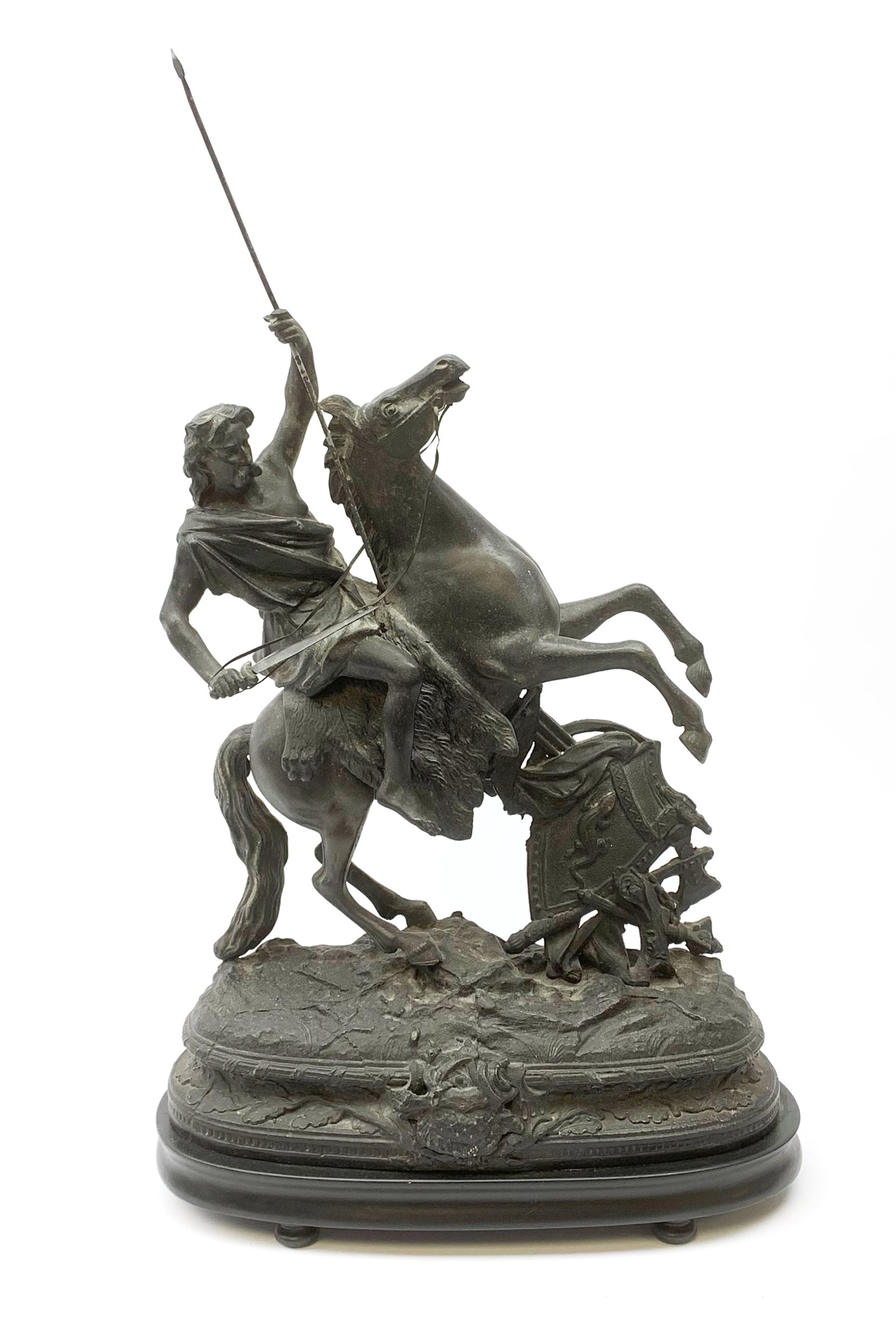 After Theodore Doriot, 19th century spelter figure of a barbarian warrior with spear and sword on a rearing horse, with battle trophies on the naturalistic base, H64cm including later ebonised wooden base