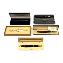 A group of pens, comprising Parker Duofold Centennial pearl and black ballpoint pen, Parker Frontier ballpoint pen, Ronson Penciliter, in original box, Parker Rialto fountain pen, and a further unmarked ballpoint. (5). 