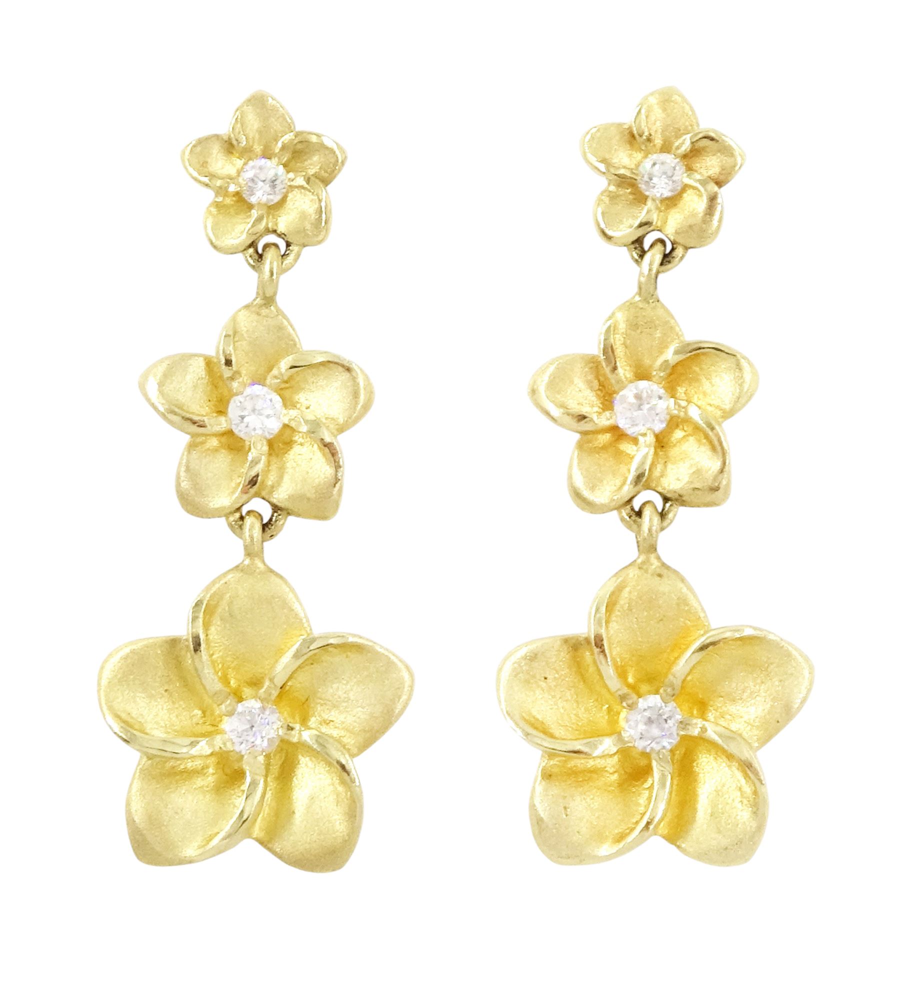 Pair of gold cubic zirconia flower head earrings, each stud with three graduating flowers, each set with a single cubic zirconia