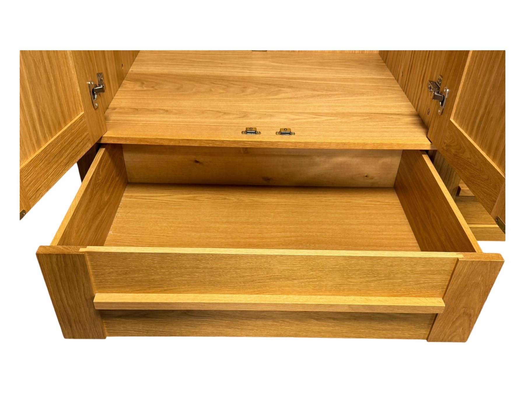 Contemporary light oak triple wardrobe, panelled doors with vertical linear design, left section enclosing hanging rail and single shelf, right section with adjustable shelves, over two drawers, on square stile supports