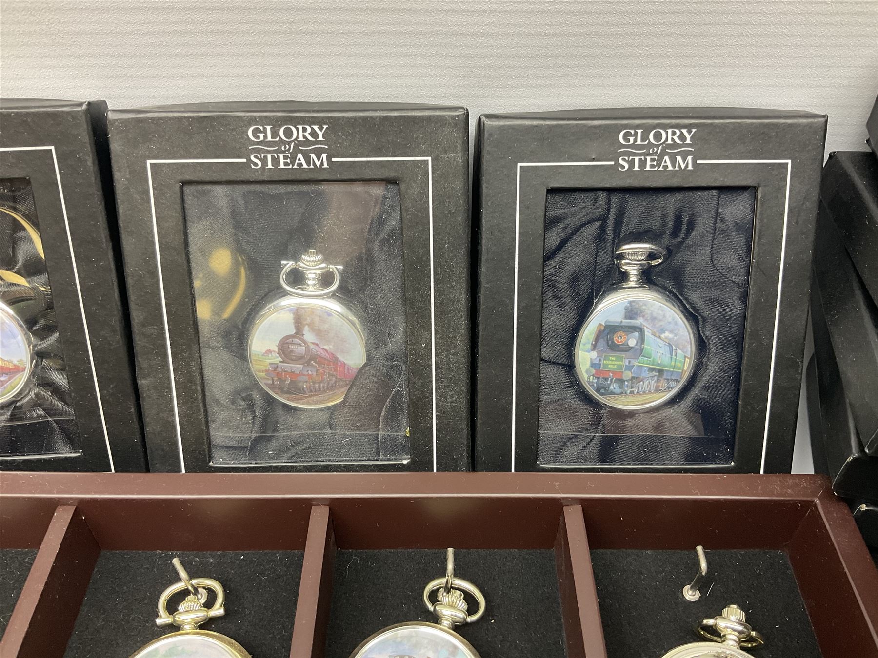 Twenty-three Glory of Steam Atlas Editions silver plated pocket watches, to include The Scottish Horse, Merchant Navy Class, etc, with wood display case, all boxed, twenty one with certificates