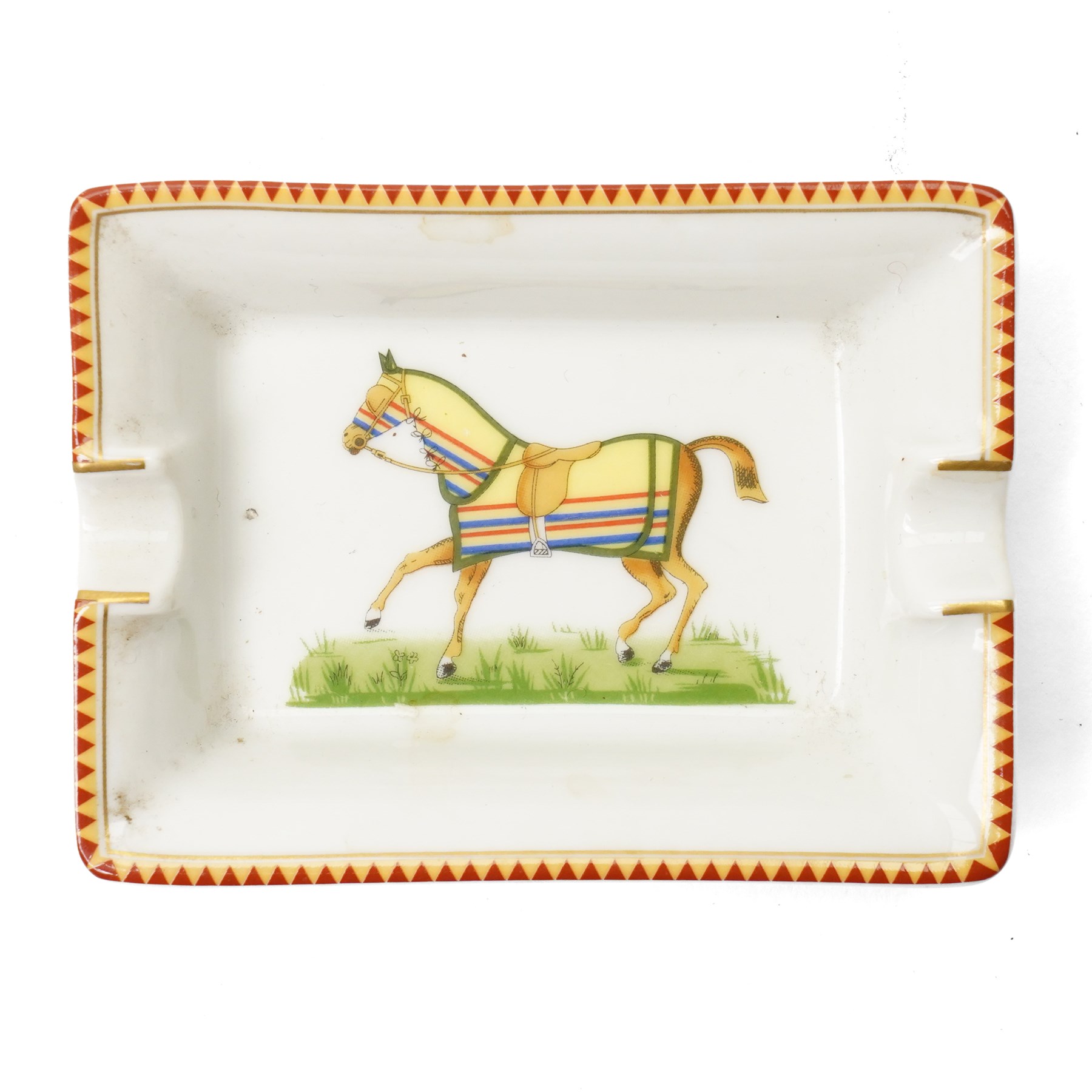 Hermès - set of four miniature porcelain ashtrays, each decorated with a horse in differing blanket, with gilt and coloured borders, in contrasting colour with various horse-coats, in original fitted box