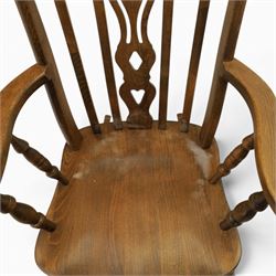 Farmhouse elm rocking chair, high back with 'Fleur De Lis' splat, shaped arms above turned supports, on rocker base 