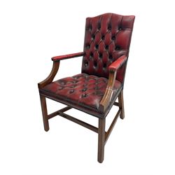 Georgian design mahogany framed Gainsborough style library armchair, upholstered in buttoned oxblood leather with studwork border
