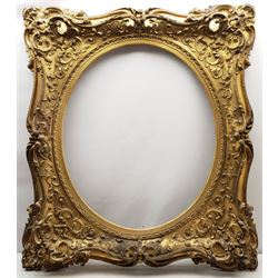 FRAMES - Magnificent 19th century swept giltwood and gesso frame, oval aperture 75cm x 63cm to fit an 80cm x 65cm picture