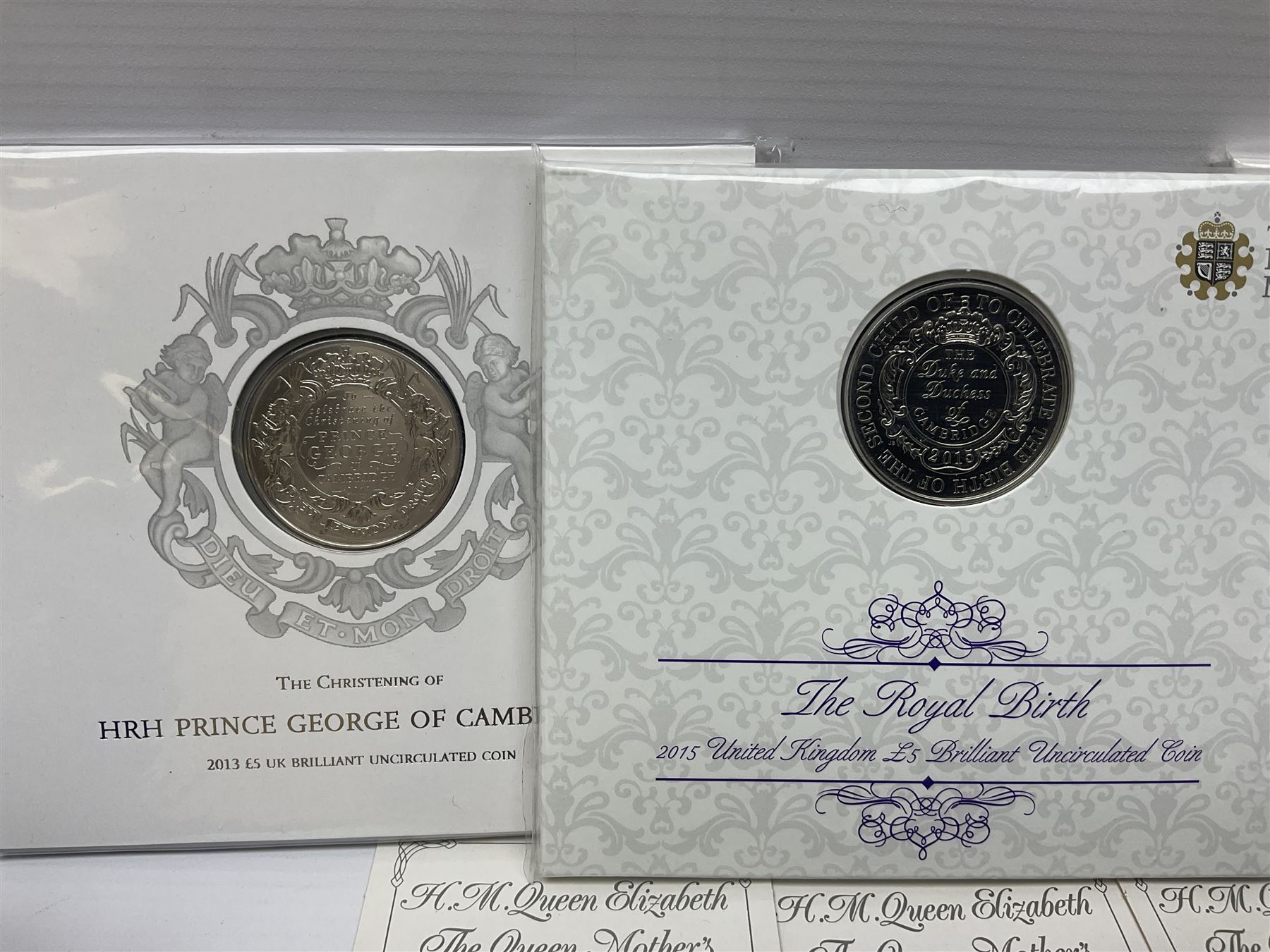 Queen Elizabeth II 1977 silver crown and 1980 silver crown, both cased with certificates, Bailiwick of Guernsey 1978 silver crown cased without certificate, three United Kingdom brilliant uncirculated five pound coins in card folders and twelve other five pound coins