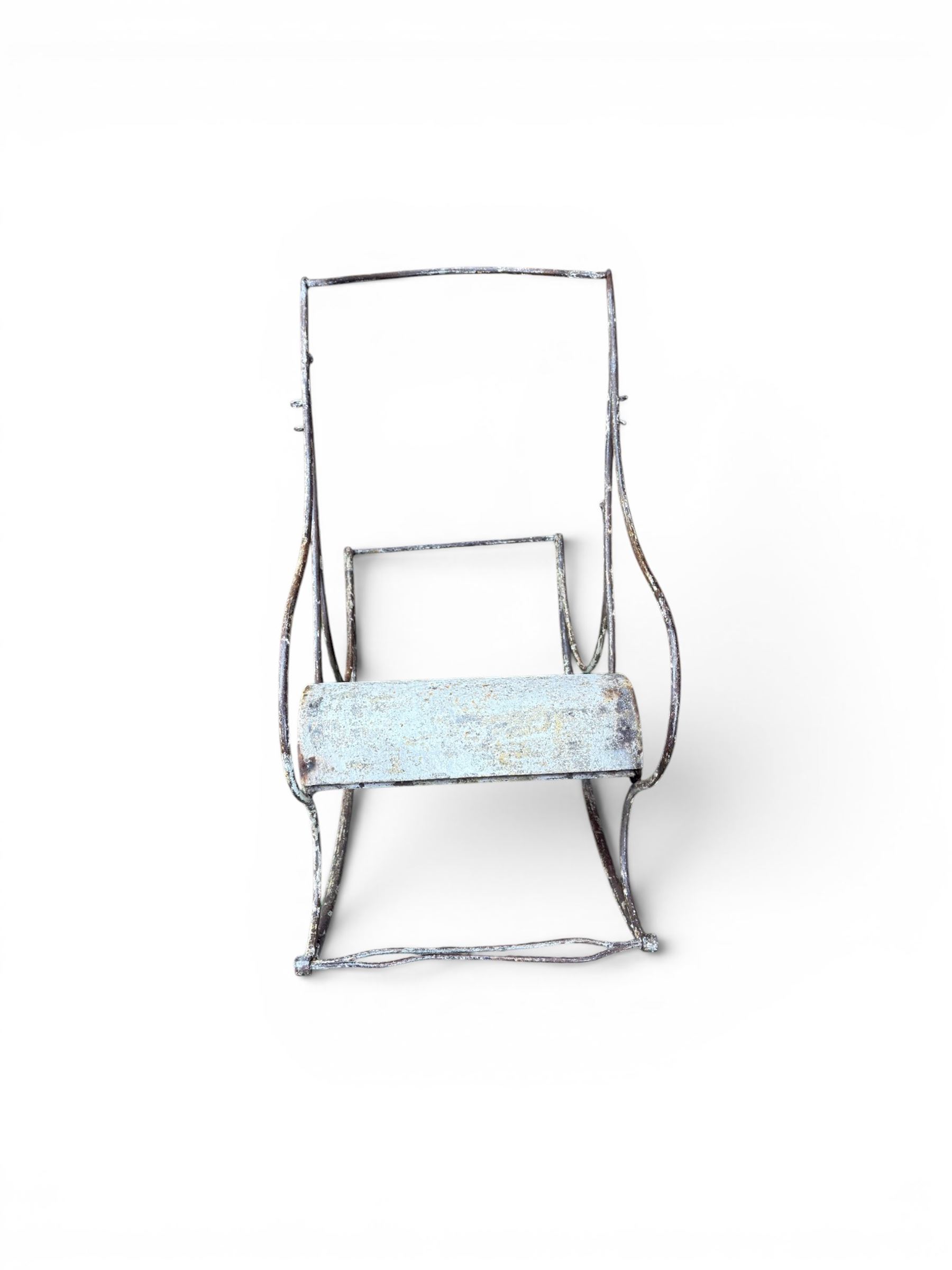 Pair of large unusual 19th century wrought iron garden rocking chairs, simple scroll design, lacking canvas seat