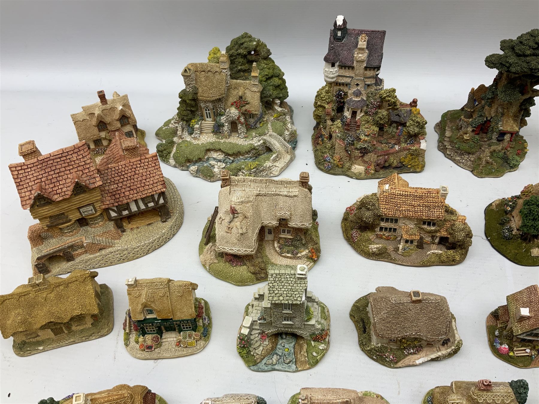 Forty six Lilliput Lane model cottages, to include 'Convent in the Woods', 'Holme Dyke' 'Secret Garden' etc