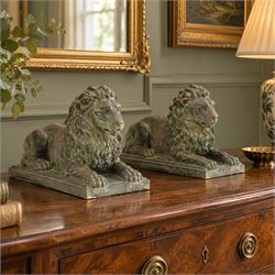 Pair of bronze-effect composition stone recumbent lions, with verdigris-style weathered fi...