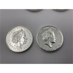 Seven Queen Elizabeth II United Kingdom fine silver twenty pound coins comprising 2014 ‘Honour the Fallen of WWI’, 2015 ‘Longest Reigning Monarch’ and ‘Winston Churchill’, 2016 ‘The Nativity Story’, ‘The 90th Birthday of Queen Elizabeth II’ and ‘The Welsh Dragon’, and 2018 ‘St. George and the Dragon’ 