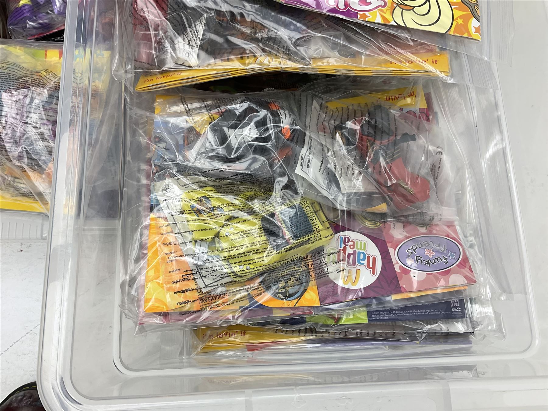 Large quantity of Mcdonalds toys to include Herbie and Polly Pocket in three boxes