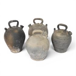 Four 20th century Spanish blackened earthenware botijo or cruche vessels, each of typical ...