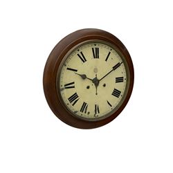 An early 20th century English wall clock with a circular 16” mahogany wooden bezel, 12” painted steel dial with Roman numerals and minute track, steel spade hands within a flat glass and spun brass bezel, eight-day rack-striking spring driven movement striking the hours on a coiled gong, with case side door and pendulum regulation door to base, dial inscribed with the trademark BUC Ltd . 
( British United Clock Company 1885-1909)
With pendulum and key.



