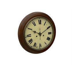 An early 20th century English wall clock with a circular 16” mahogany wooden bezel, 12” painted steel dial with Roman numerals and minute track, steel spade hands within a flat glass and spun brass bezel, eight-day rack-striking spring driven movement striking the hours on a coiled gong, with case side door and pendulum regulation door to base, dial inscribed with the trademark BUC Ltd . 
( British United Clock Company 1885-1909)
With pendulum and key.



