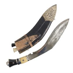 Pair of kukri knives, with with ebonised and bone handles, with two smaller knives, with a leather scabbard with floral silvered decoration, L44cm