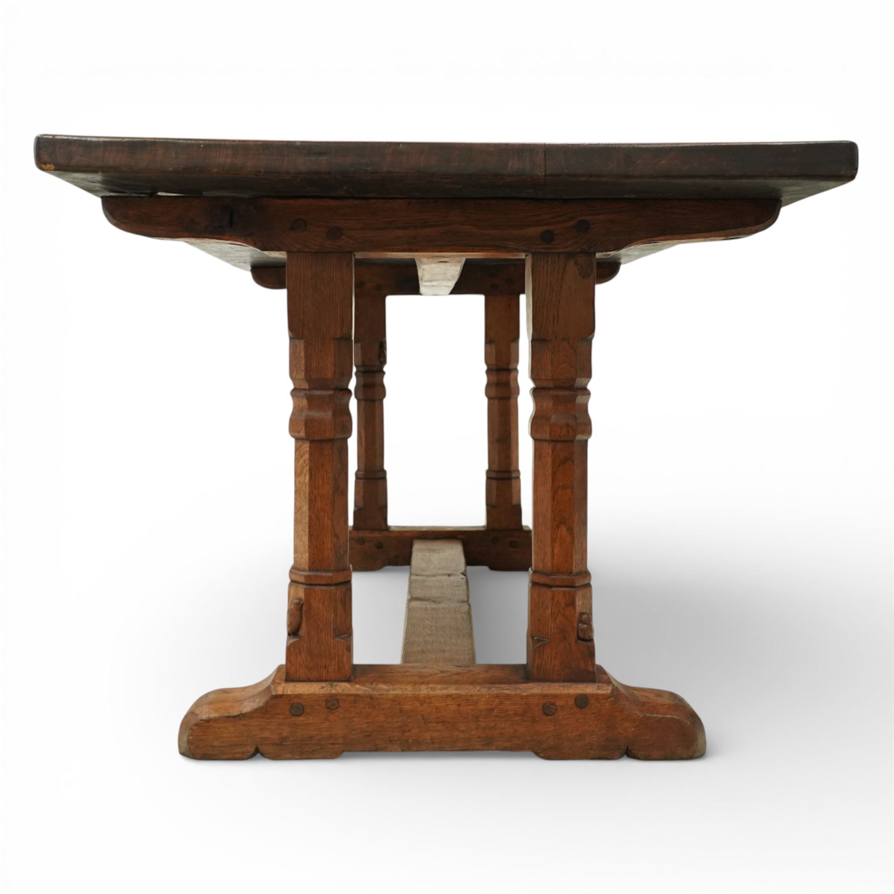 Mouseman - 1937 refectory table, Sir Herbert Baker commission for Westminster Church House, the rectangular adzed plank top above twin octagonal baluster supports united by a pegged stretcher, raised on shaped sled bases carved with a partridge and a loaf of bread, with carved mouse signature to inside leg, by Robert Thompson of Kilburn

The carved loaves reference the original patron, while the partridges are thought to represent Frank Partridge, Bishop of Portsmouth from 1877 to 1941, who played a key role in the founding of Church House and served as its Secretary from 1936 until 1941

Reference
Christie’s ROBERT “MOUSEMAN” THOMPSON; Refectory Table, Lot 188, sold at Christie’s London, commissioned by Sir Herbert Baker KCIE, RA, architect of Church House (opened 1937). Provenance and description available on the Christie’s website
https://www.christies.com/en/lot/lot-4618786