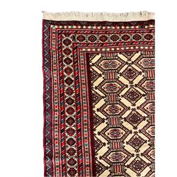 North East Persian Turkoman rug, ivory ground field decorated with repeating Gul motifs, multi-band border decorated with geometric patterns and motifs