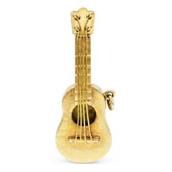 Two gold pendants / charms including 17ct guitar and a 9ct articulated lady in a shoe, London 1964