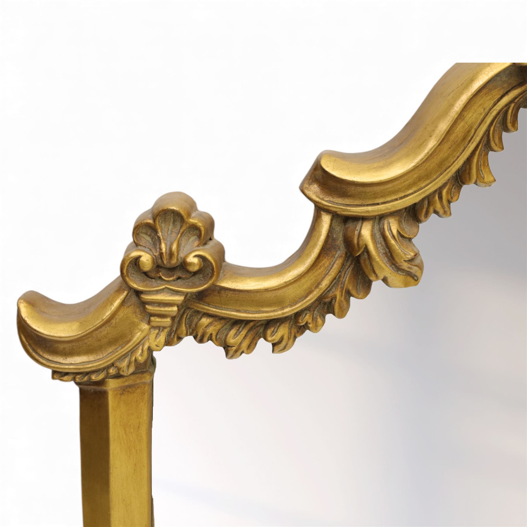 Late 20th century giltwood and composition over mantel mirror, with shaped and scrolled cresting centred by a shell cartouche, with foliate moulded shoulders and lower rail framing a rectangular plate