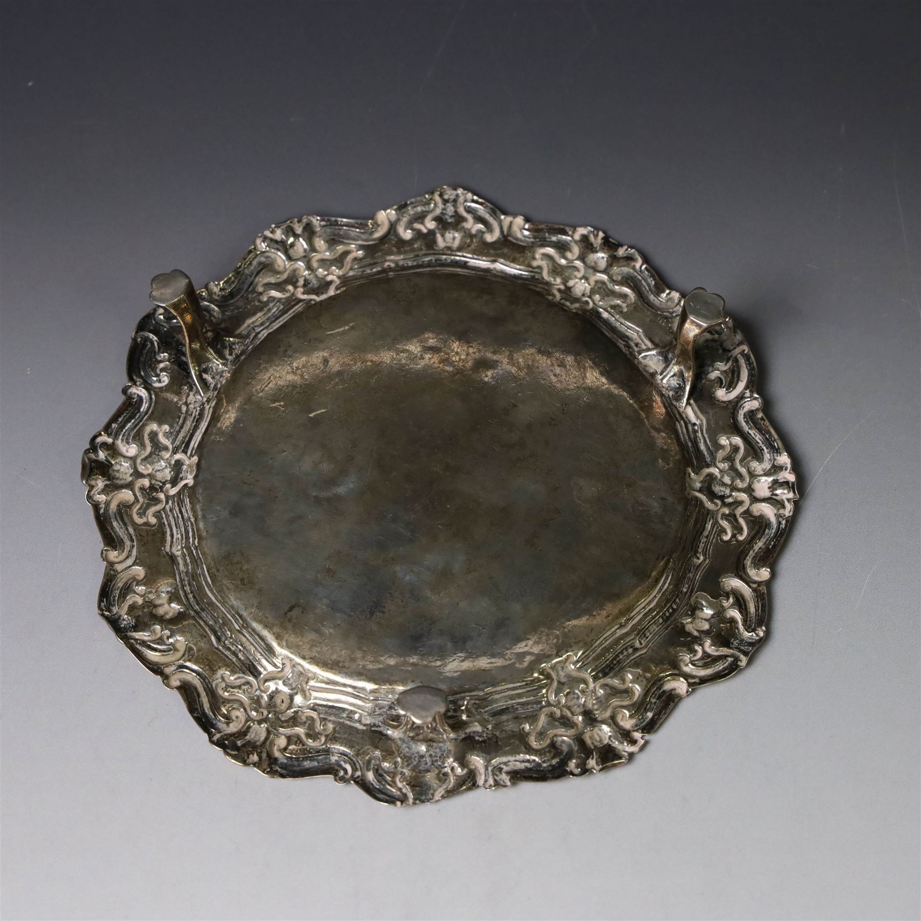 19th century continental silver waiter, of hexagonal form with stipple and scroll border, engraved with floral decoration to centre, upon three stylised paw feet, W19.2cm