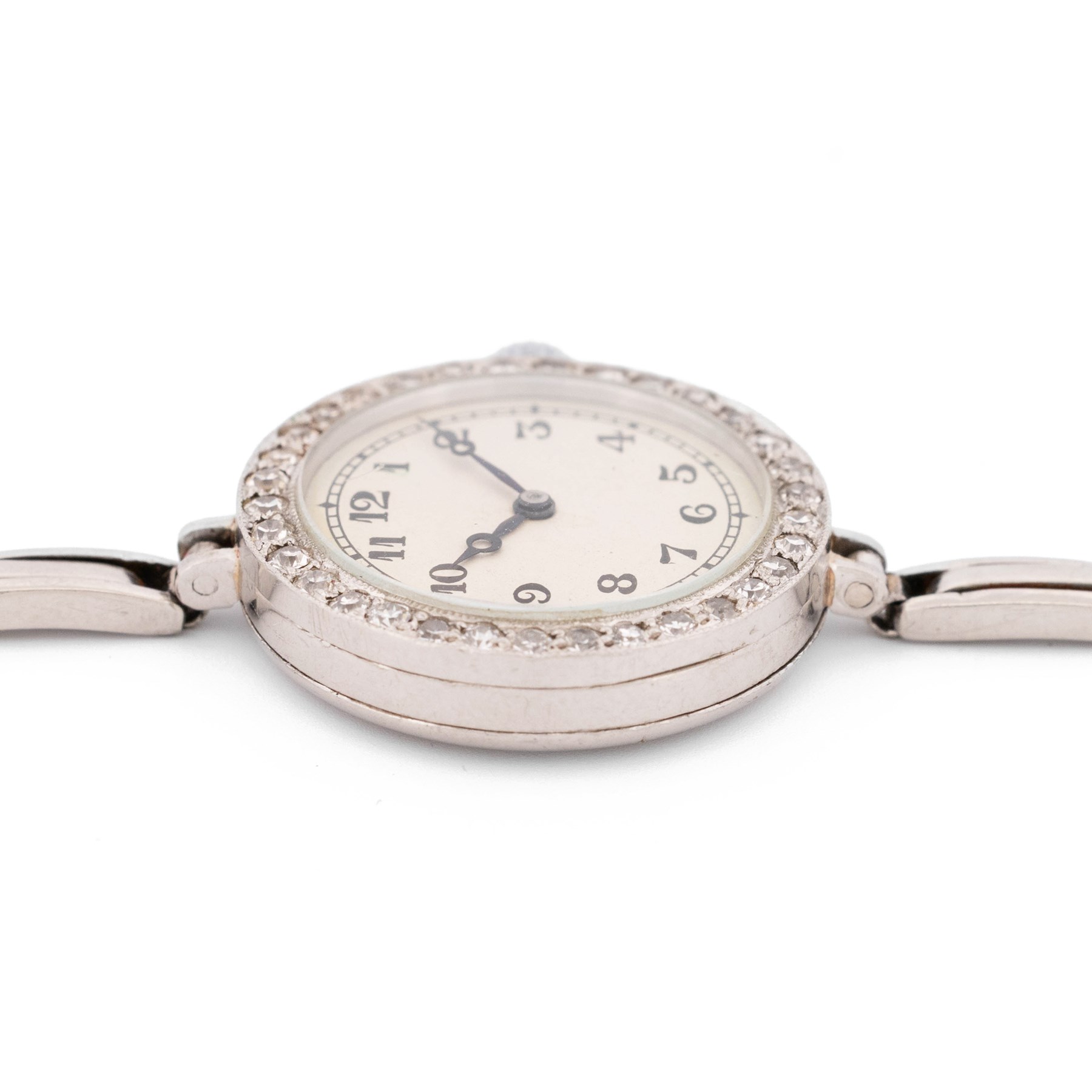 Audemars Piguet & Co Art Deco ladies platinum, diamond set manual wind wristwatch, movement No. 19931, cream / silvered dial with Arabic hour markers, the bezel milgrain set with round cut diamonds, to a platinum expanding bracelet