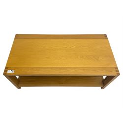 Light oak rectangular coffee table, with exposed finger joints to the corners, raised above a full-length undertier on straight supports