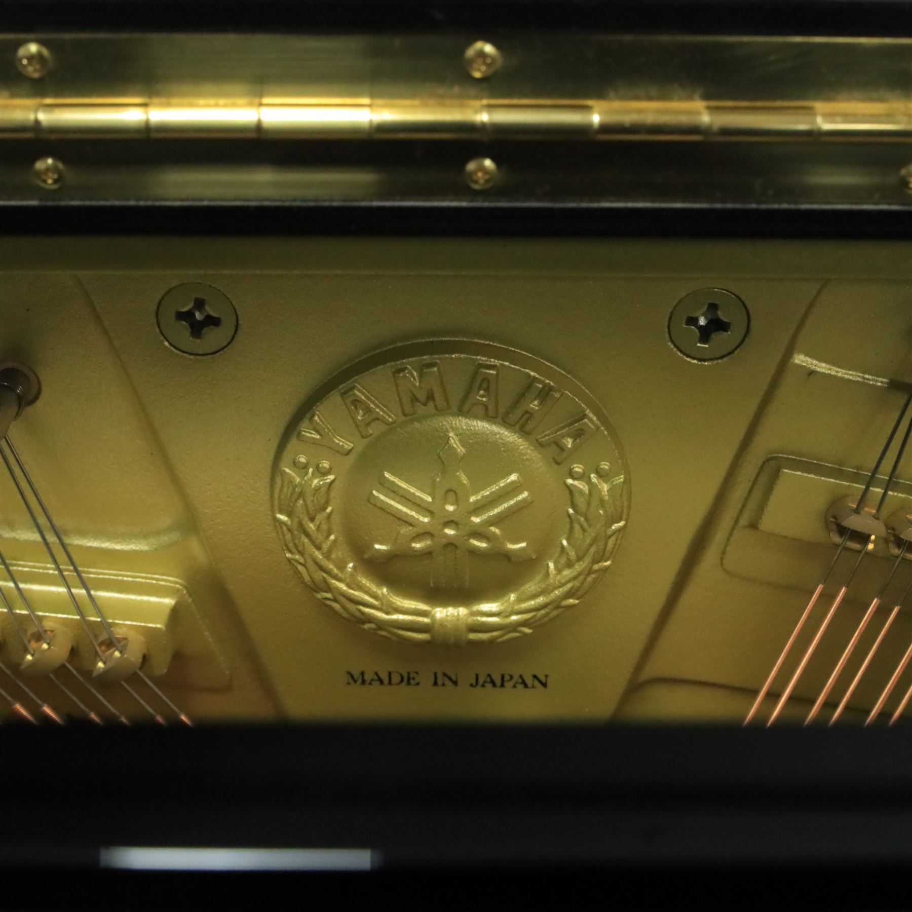 Yamaha model U5 upright piano retailed by Harrods, 88 keys and three pedals within high gloss ebonised case, serial no. 6055292, with Roland black button top piano stool