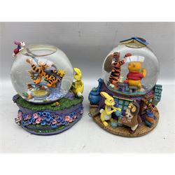 Five Disney Winnie The Pooh snow globes, to include Pooh and Piglet Sailing, Pooh's Grand Adventure and Blustery Day, together with The Walt Disney Classic Waterglobe collection globe and group Tigger, Winnie and Piglet figure under dome, all with boxes (7)